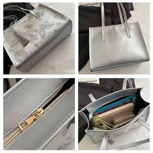 Silver butterfly tote bag with tassel showing spacious interior for tablet and umbrella