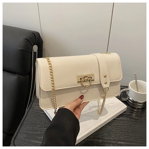 Detail of cream flap shoulder bag with gold square twist lock and chain strap