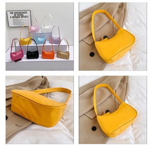 Detail view of mini underarm bag colors and textured PU leather shoulder strap finish