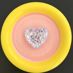 Detail of heart-shaped glitter phone socket with purple and silver sequins
