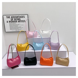 Collection of minimalist baguette underarm bags in nine vibrant matte candy colors