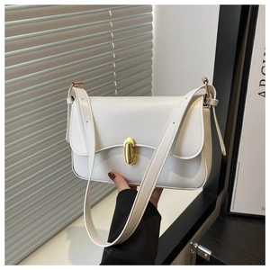 Detail of white rectangle shoulder bag featuring a gold bar twist lock and adjustable strap