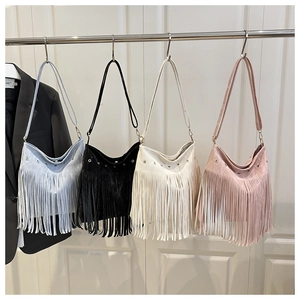 Selezione di borse quadrate con nappe in blu, nero, beige e rosa esposte su un supporto
