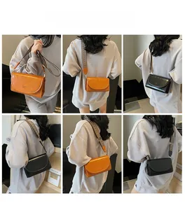 Fashionable crossbody square bag with wide ethnic pattern strap shown on model