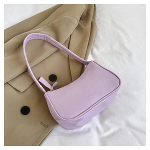 Detail of light purple baguette bag with matte leather finish and matching shoulder strap