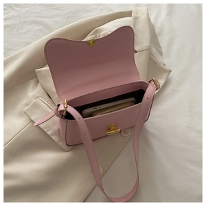 Pink leather crossbody bag interior showing storage space for phone and gold wallet
