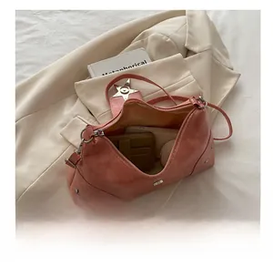 Pink crescent bag interior showing capacity for phone, wallet, and cosmetics