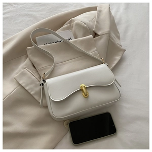 Macro view of white PU leather bag with golden metal bar lock and adjustable strap