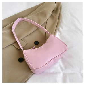 Pink PU leather minimalist underarm bag on soft white fabric background
