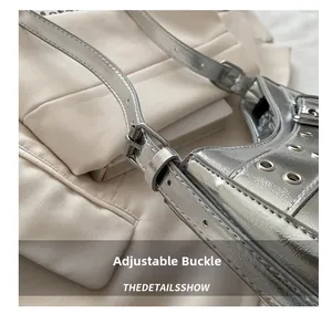 Detail of adjustable buckle and silver metallic strap with eyelets on Y2K shoulder bag