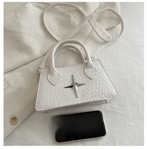 Detailed weave texture on white crossbody bag featuring a silver star metal ornament