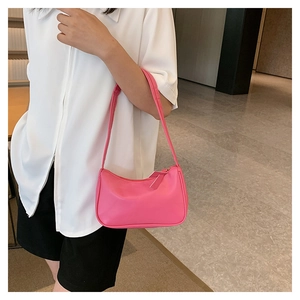 Detail of pink PU leather hobo bag with smooth finish and slender shoulder strap