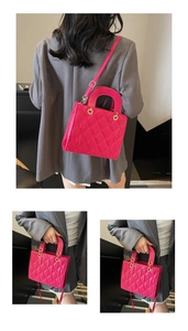 Detail of rose red quilted crossbody bag with diamond stitching and round handle
