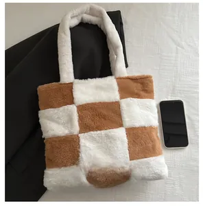 Size comparison of a brown checkerboard faux fur tote bag next to a smartphone