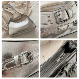 Detail of silver metallic Y2K shoulder bag showing metal eyelets and adjustable buckle strap