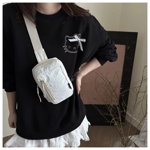 Close-up of white pleated nylon chest bag with zip pockets shown on a model