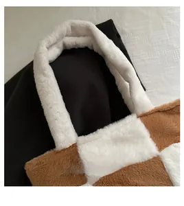Close-up of fluffy plush tote bag with brown and white checkerboard pattern and wide strap