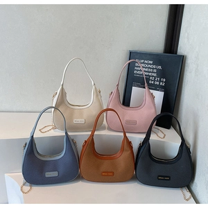 Five woven leather crescent armpit bags in various colors with gold chain accents