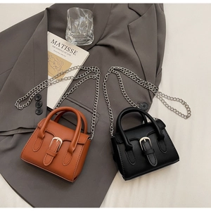 Detail of mini chain handbags in brown and black leather with silver buckle and metal strap