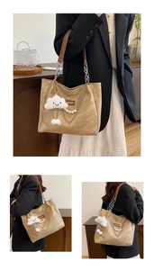 Detail of a large tote bag featuring pearl chain charms and a cute cloud plush pendant