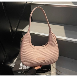 Detailed view of pink woven hobo bag featuring golden chain and Miss mini logo detail