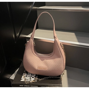 Detail of pink woven leather shoulder bag with gold chain and Miss mini logo plaque
