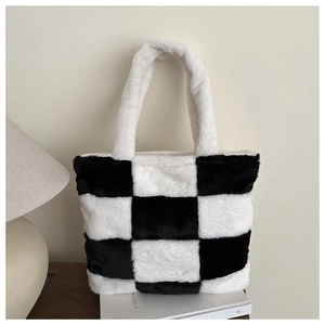 Close-up of fluffy black and white checkerboard plush tote bag with soft faux fur texture