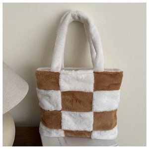 Close-up of fluffy brown and white checkered faux fur tote bag in a cozy home setting