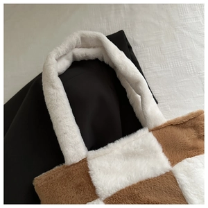 Detail of the brown and white checkerboard plush tote bag showing soft fleece texture