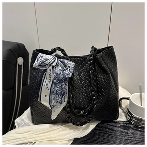 Close-up of black woven tote bag featuring a decorative France print silk scarf handle