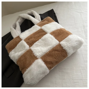 Close-up of plush checkerboard tote bag with brown and white faux fur texture
