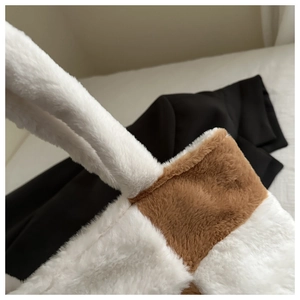 Close-up of the plush faux fur texture and checkerboard pattern on the tote bag handle