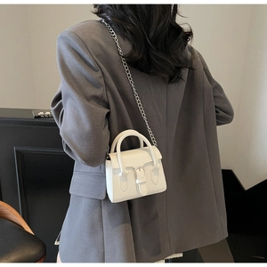Detailed back view of a white mini PU leather crossbody bag with silver chain strap