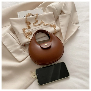 Brown half-moon shoulder bag shown with a smartphone for precise size comparison