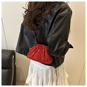 Detailed back view of red floral puff crossbody bag with white flower patterns