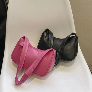 Minimalist candy-colored hobo underarm bags in bright pink and classic black faux leather