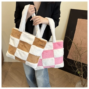 Detail of plush checkerboard tote bags in brown and pink showing soft fuzzy texture