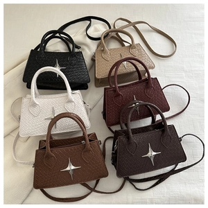 Detailed view of small woven square bags in six colors with star buckle accents
