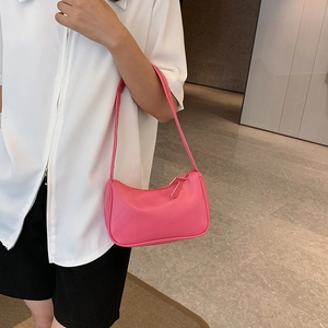 Pink minimalist underarm baguette bag with smooth texture and silver zipper detail