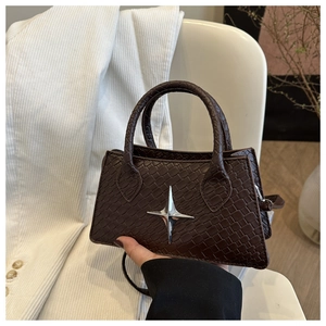Close-up of brown woven texture mini bag with silver star metal detail and hard handles
