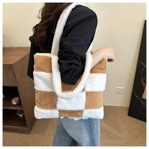 Detailed plush brown and white checkerboard pattern on a large soft tote bag