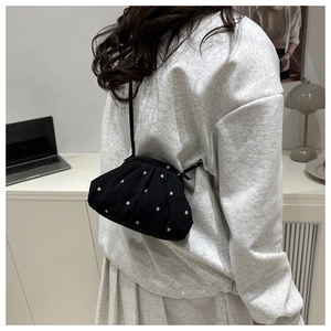 Sac fourre-tout nuage noir à motif floral porté par un mannequin dans un bureau moderne