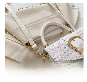 Detail of cream woven leather flap bag with gold buckle and adjustable strap