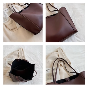 Detail view of large dark brown leather tote bag with interior pockets and textured finish