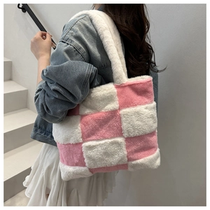 Detail of pink and white checkered plush tote bag showing soft fuzzy texture and strap