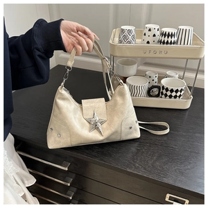 Detail of off-white punk shoulder bag featuring 3D silver star and metal rivets