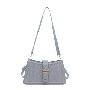 Minimalist light blue baguette shoulder bag with crinkled texture and gold metal buckle