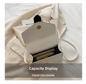 Internal view of a white leather crossbody bag showing space for phone and wallet