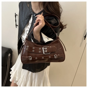 Detailed view of the dark brown crescent bag with metal buckles and stripe lining