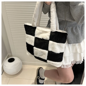 Detail of plush black and white checkerboard tote bag showing soft faux fur texture